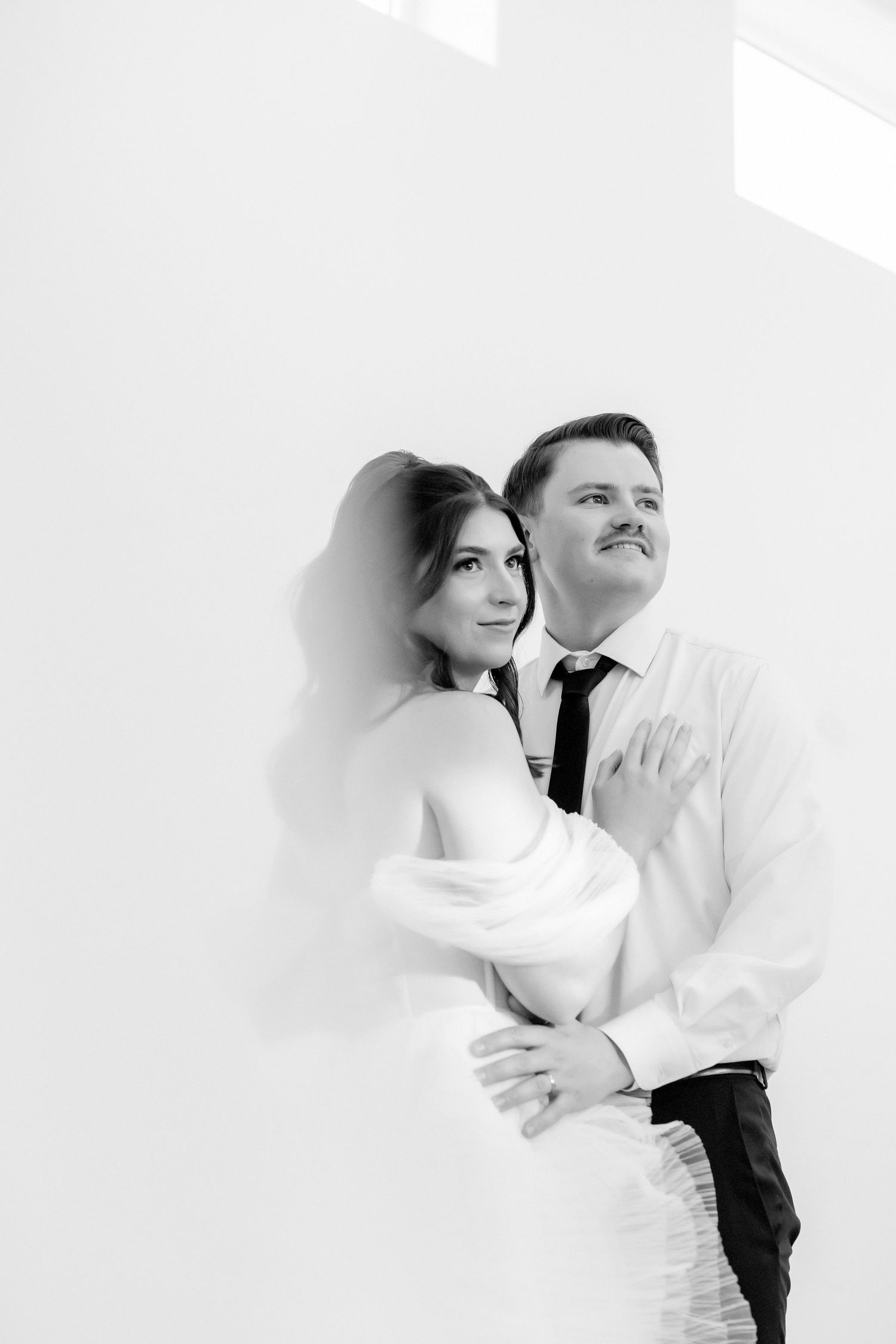 Black and white image of couple looking off camera Milestones Studios LLC at Magnolia Reserve