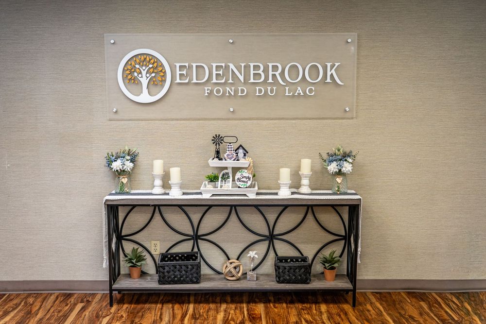 Edenbrook Fond du Lac lobby entrance with decorative console table, candles, and elegant signage. Branding by Sam Lauersdorf Photography
