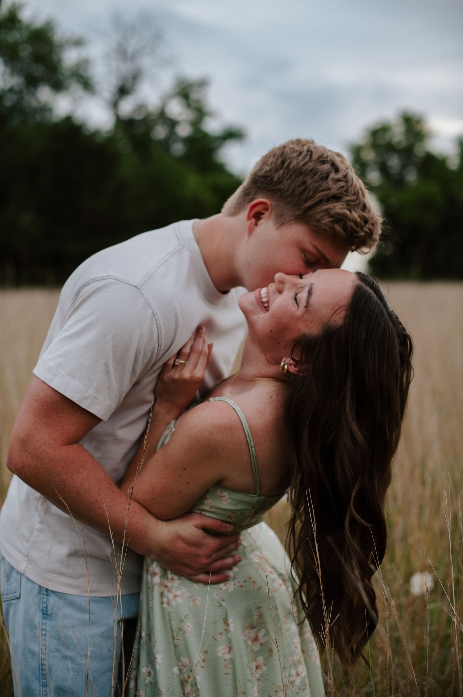 Wichita KS outdoor engagement photos in nature location Andover, couple photos in field with flowers, small elopement wedding photographer