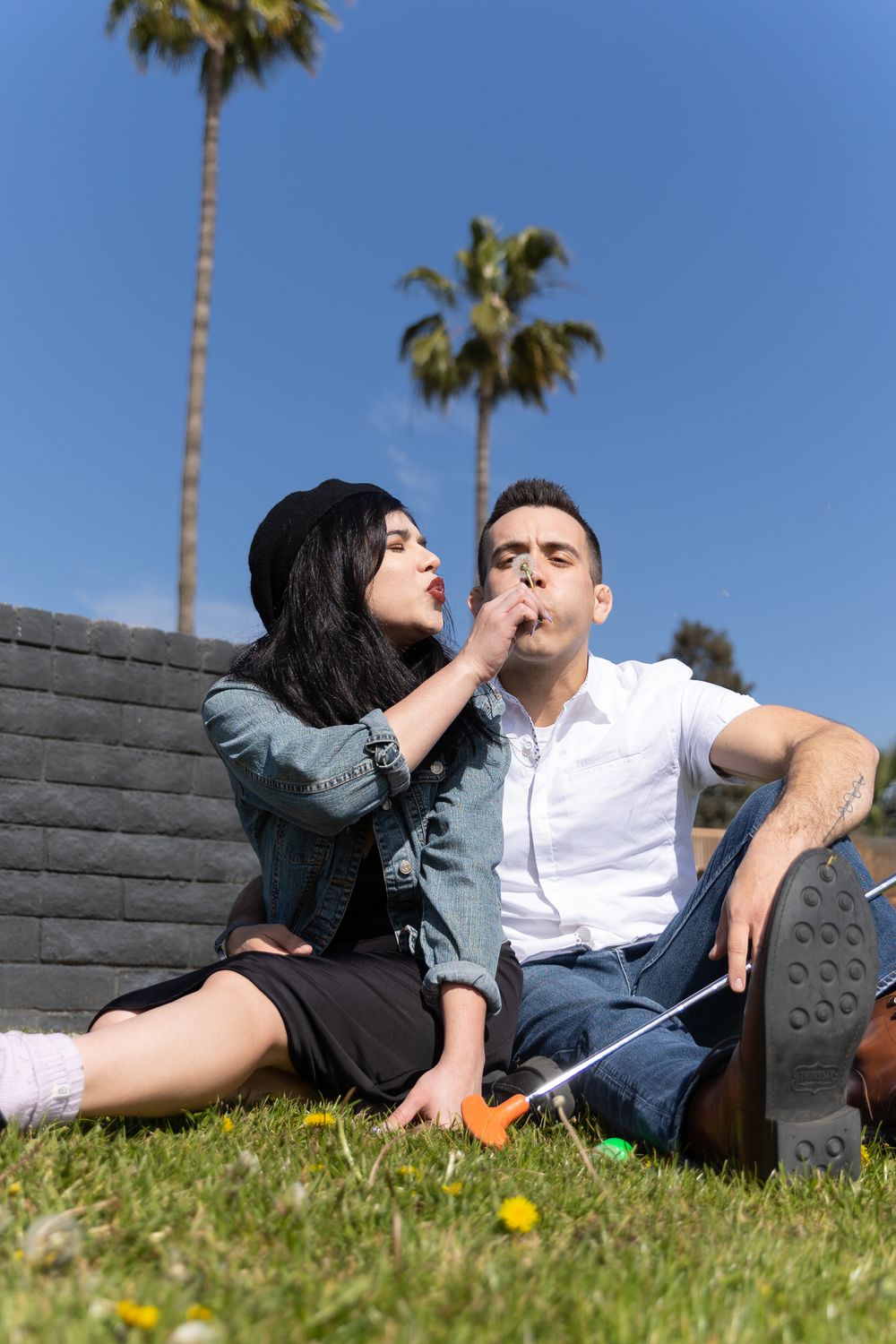 Couple sitting and holding each other at a mini golf course during their engagement session