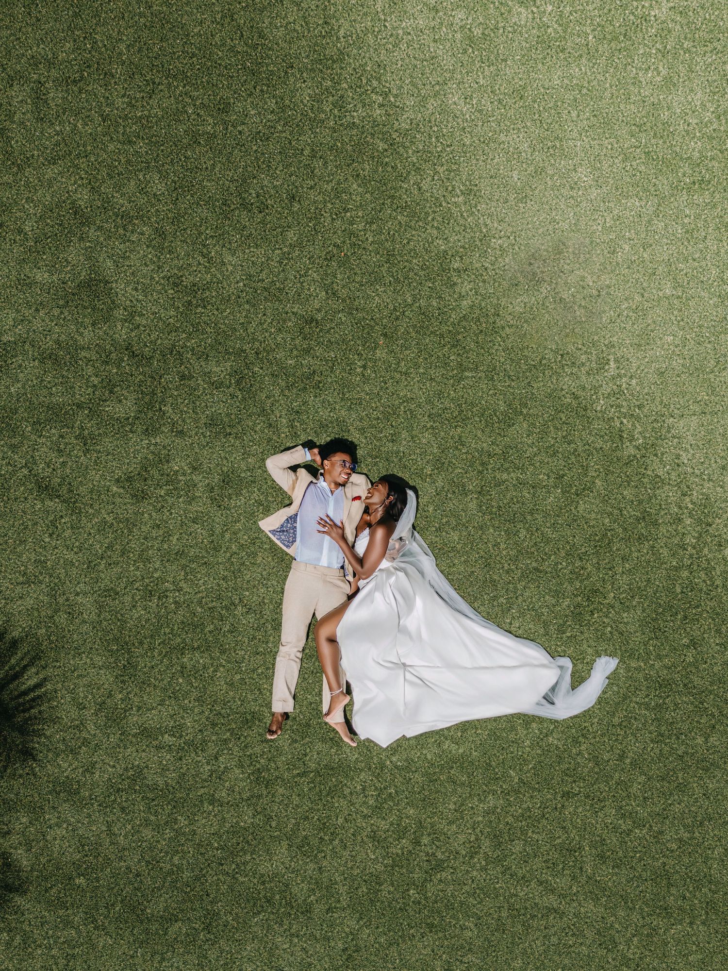A romantic seaside wedding photoshoot with a flowing white veil catching the ocean breeze.