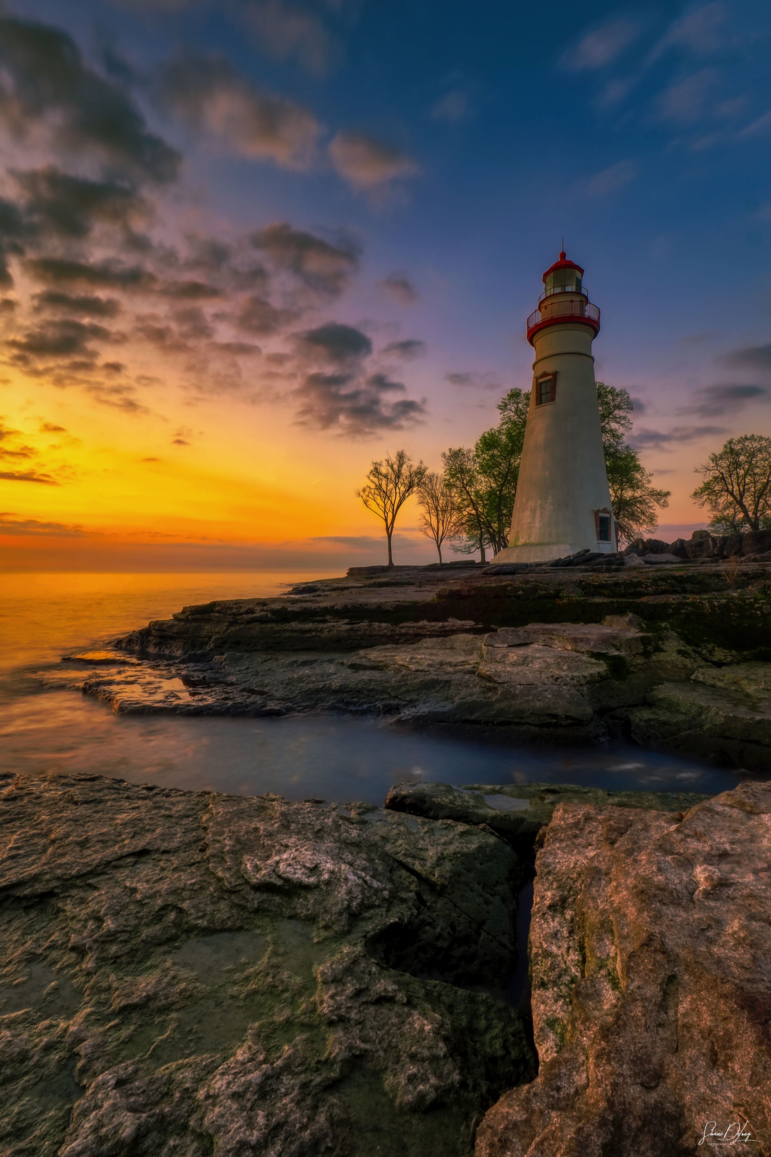 Historic Marblehead Lighthouse at sunrise on Lake Erie, captured as fine art coastal photography showcasing maritime heritage and atmosphere