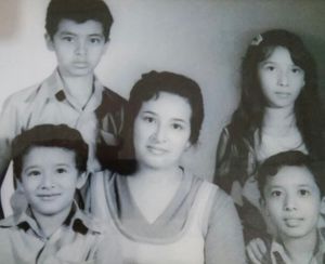 A black and white photo strip showing a series of vintage school portrait style headshots arranged horizontally.