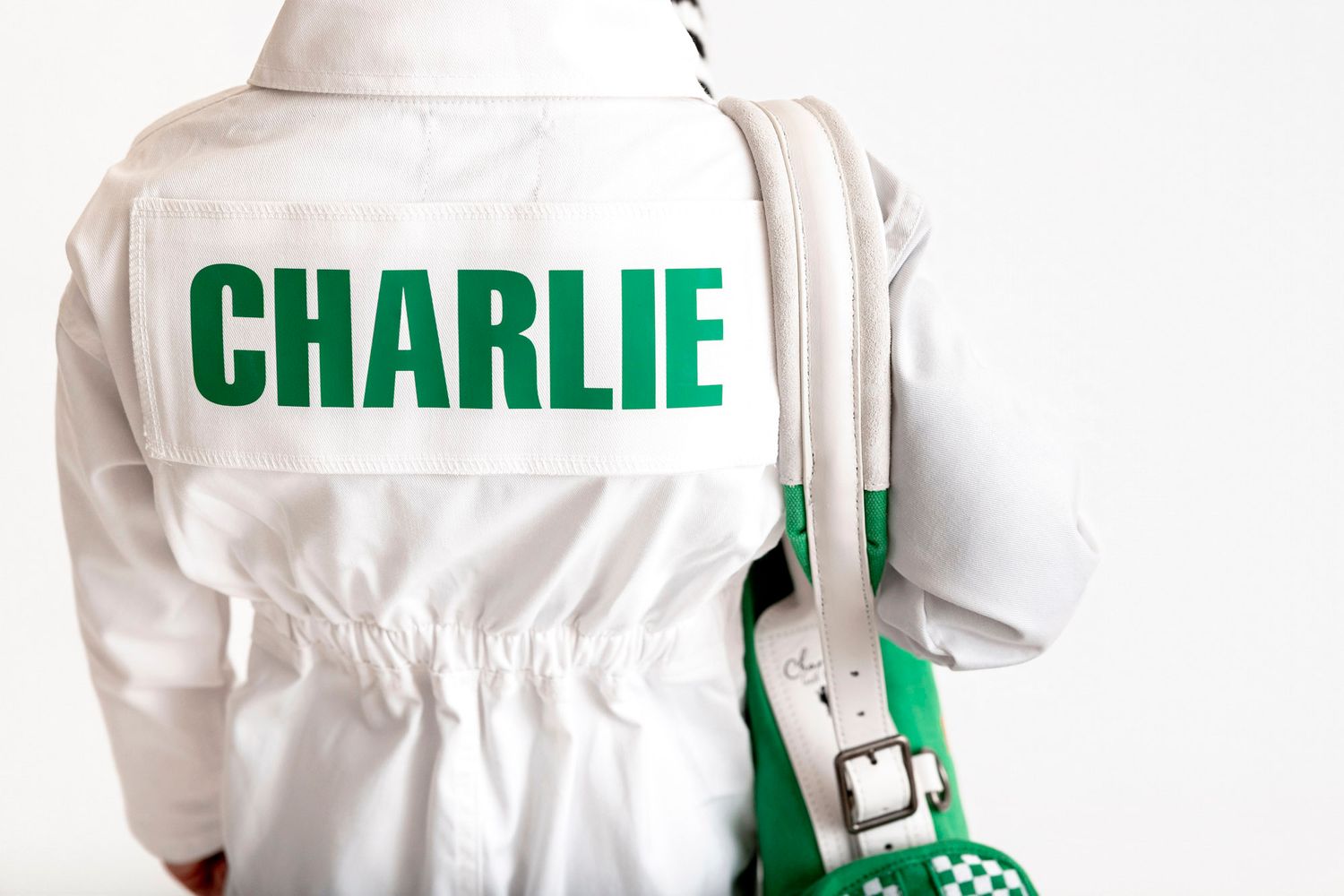 Child modeling white golf caddy uniform holding a Georgia inspired kids golf bag.