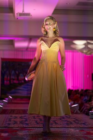 Amber Mufale walks down the Azalea spring fashion show runway 2026 in her fabulous yellow sundress
