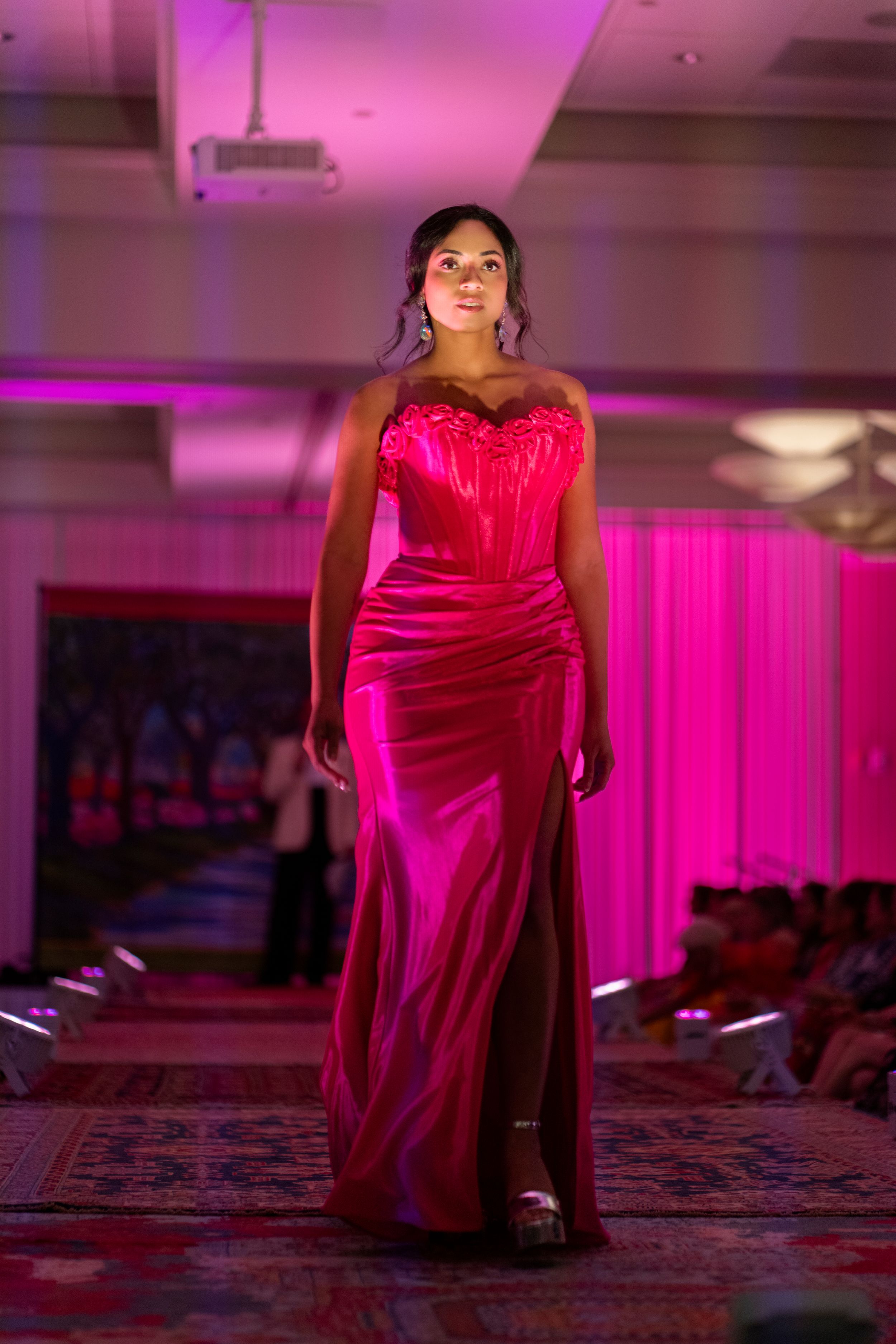 Alexandria Seabrook walks down the Azalea Festival Spring Fashion show runway 2026 showcasing Camille's  stunning pink summer gown