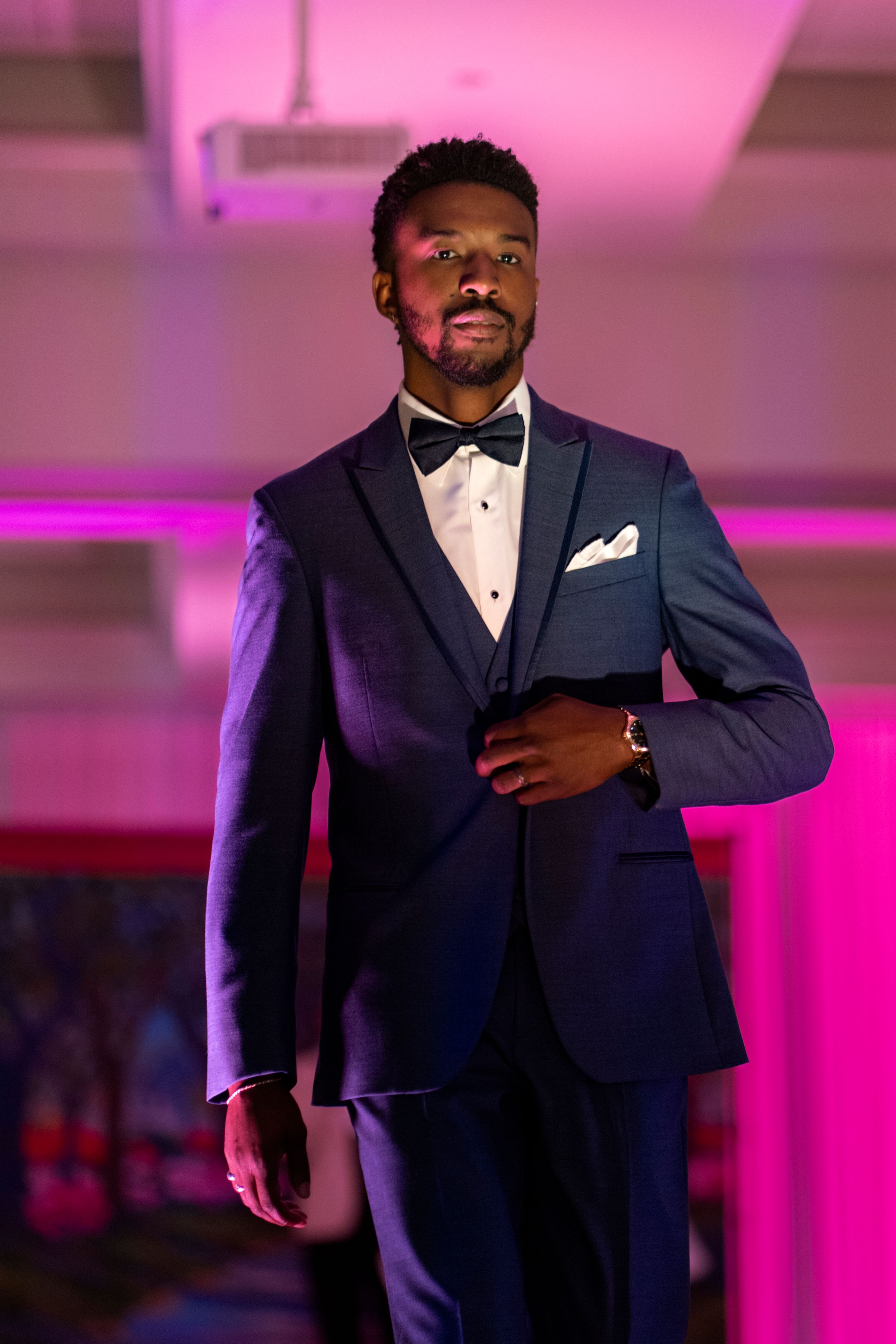 Gentlemen’s Corner model Cj Grae in his navy blue tuxedo walking down the runway during the Azalea festival spring fashion show 2026