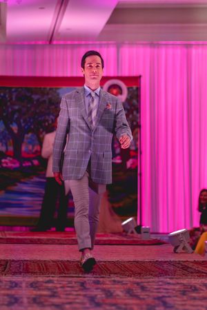 Jesse Davis walks down the runway during the Azalea spring fashion show 2026 in a grey plaid suit