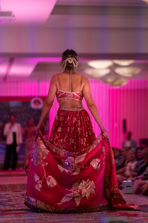 A model twirls in a red beaded Indian sari during the Azalea spring fashion show runways 2026 located at holiday inn resort