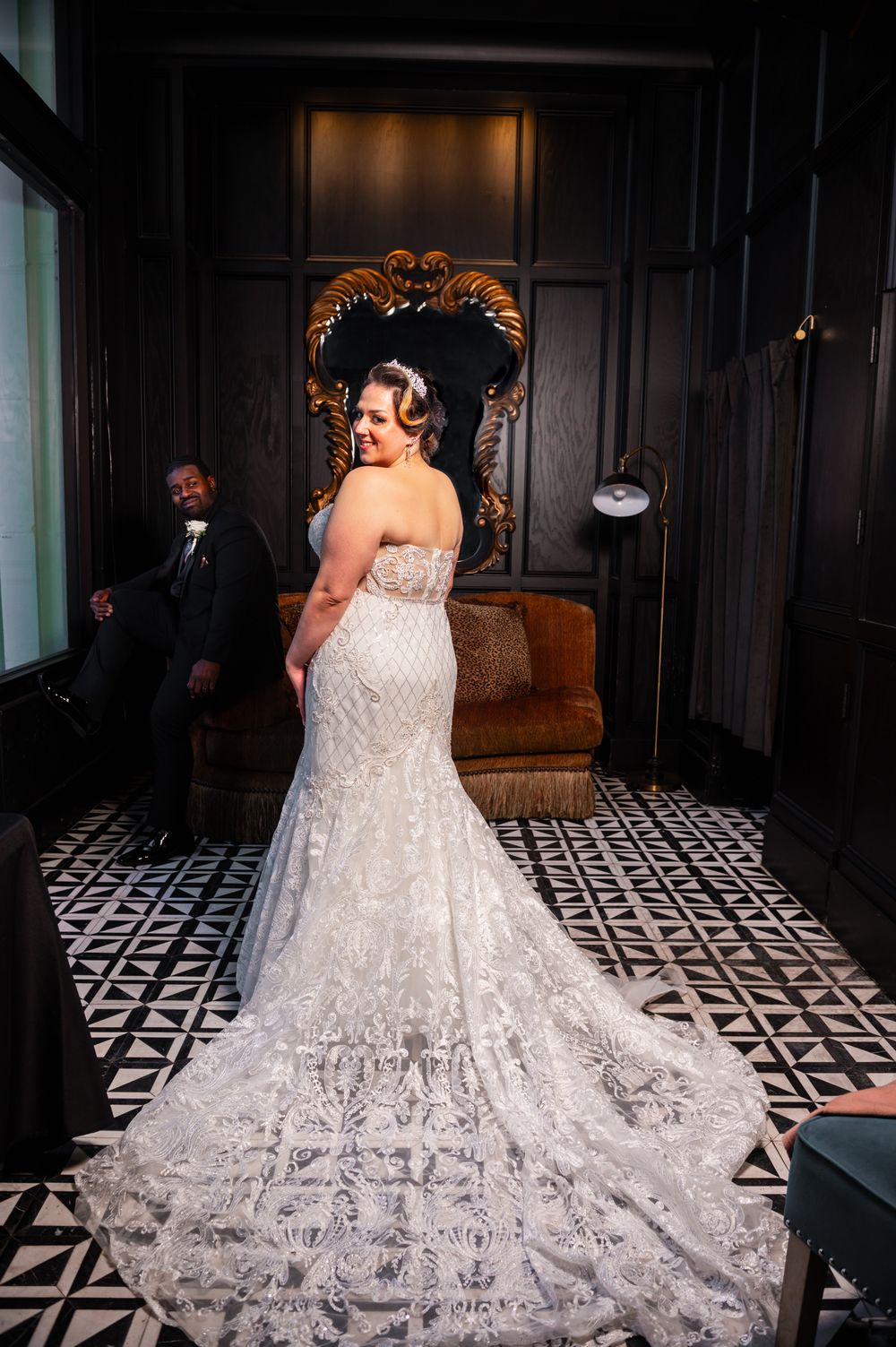 She looks over her shoulder as her groom looks at her.