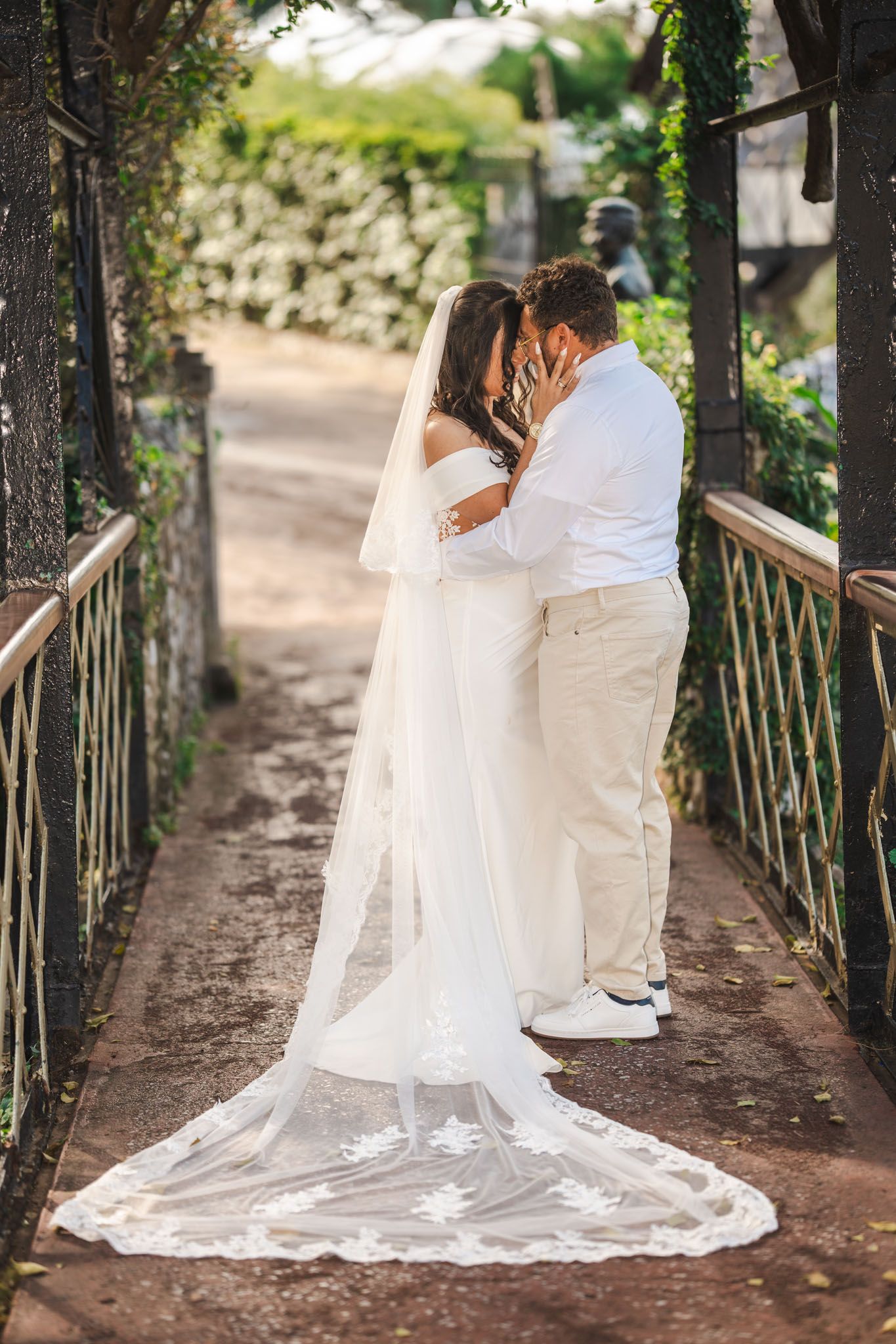Wedding couple embrace in botanical gardens, Gibraltar