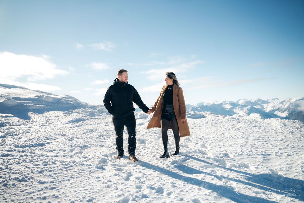 Couple holding hands and smiling at each other on snowy mountain summit.

Vancouver Canada Scene
