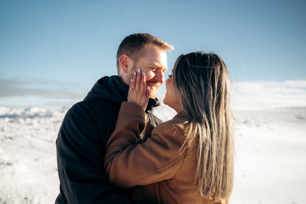 Romantic couple sharing a tender moment, woman touching mans face in snowy setting.

Vancouver Canada Scene