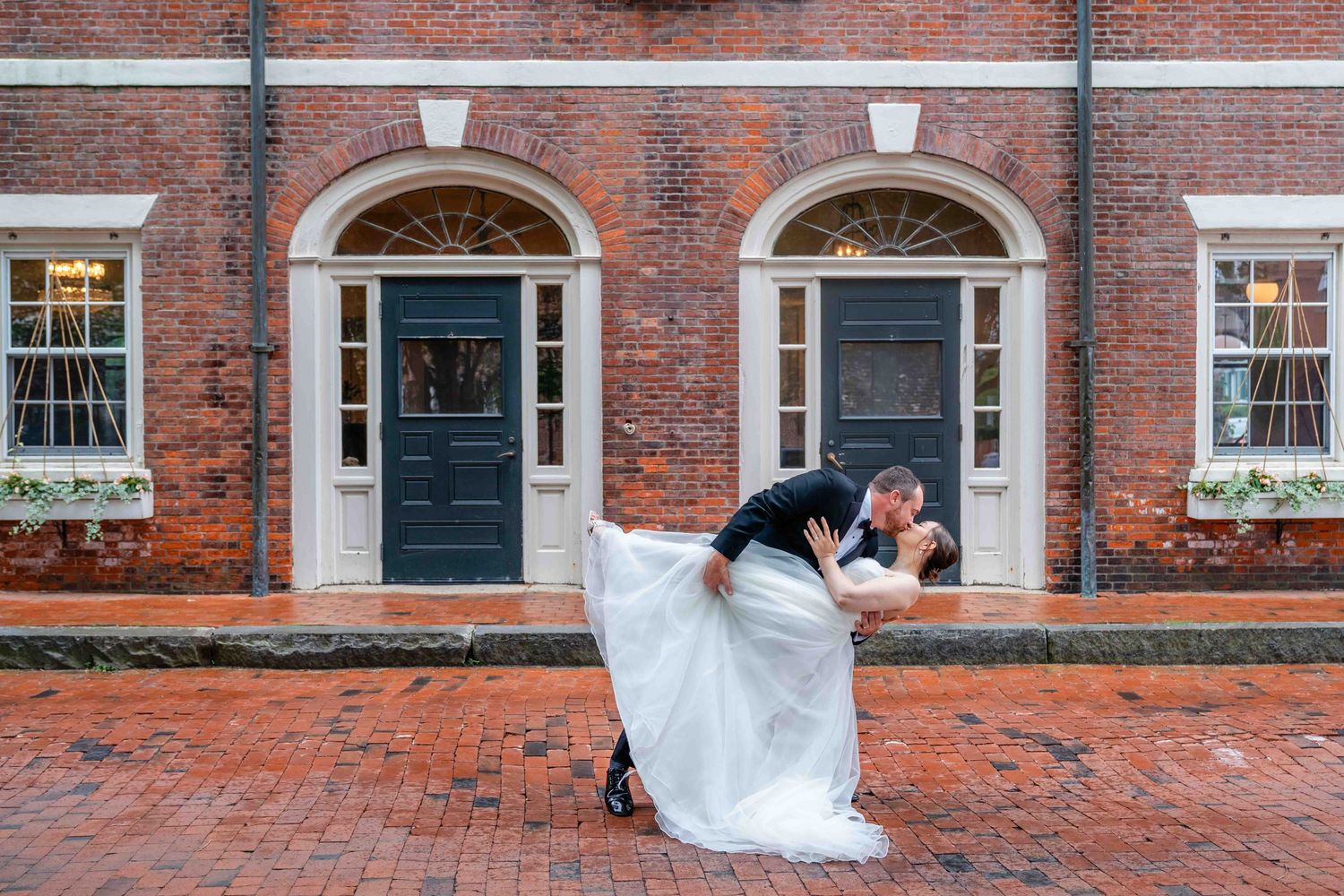 Couple doing a dip kiss at The Garrison Hotel in Newburyport, MA after their city hall wedding ceremony.