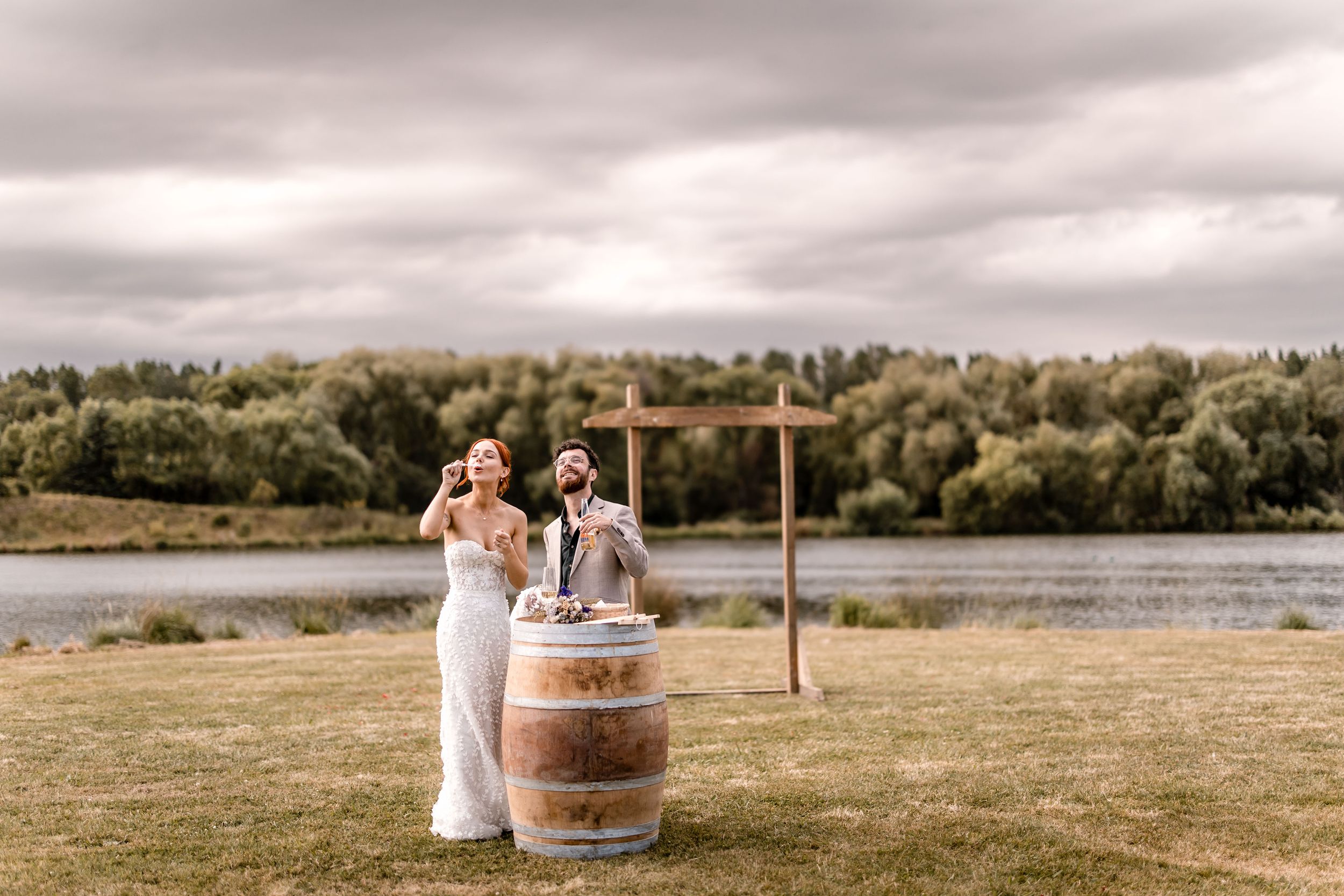 Bride and Groom blowing bubbles at Back Paddock Lakes Hawkes Bay