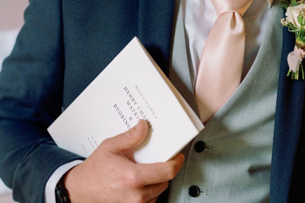 Close-up of wedding vows being read from white paper cards taken by Maddie Waters Photography