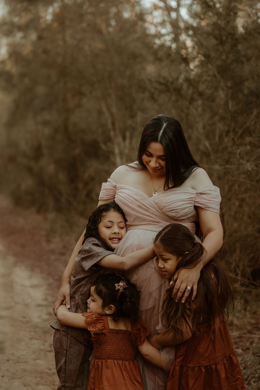 Three family members share an intimate moment together in a warm, sepia-toned outdoor setting in Sydney Family Photoshoot