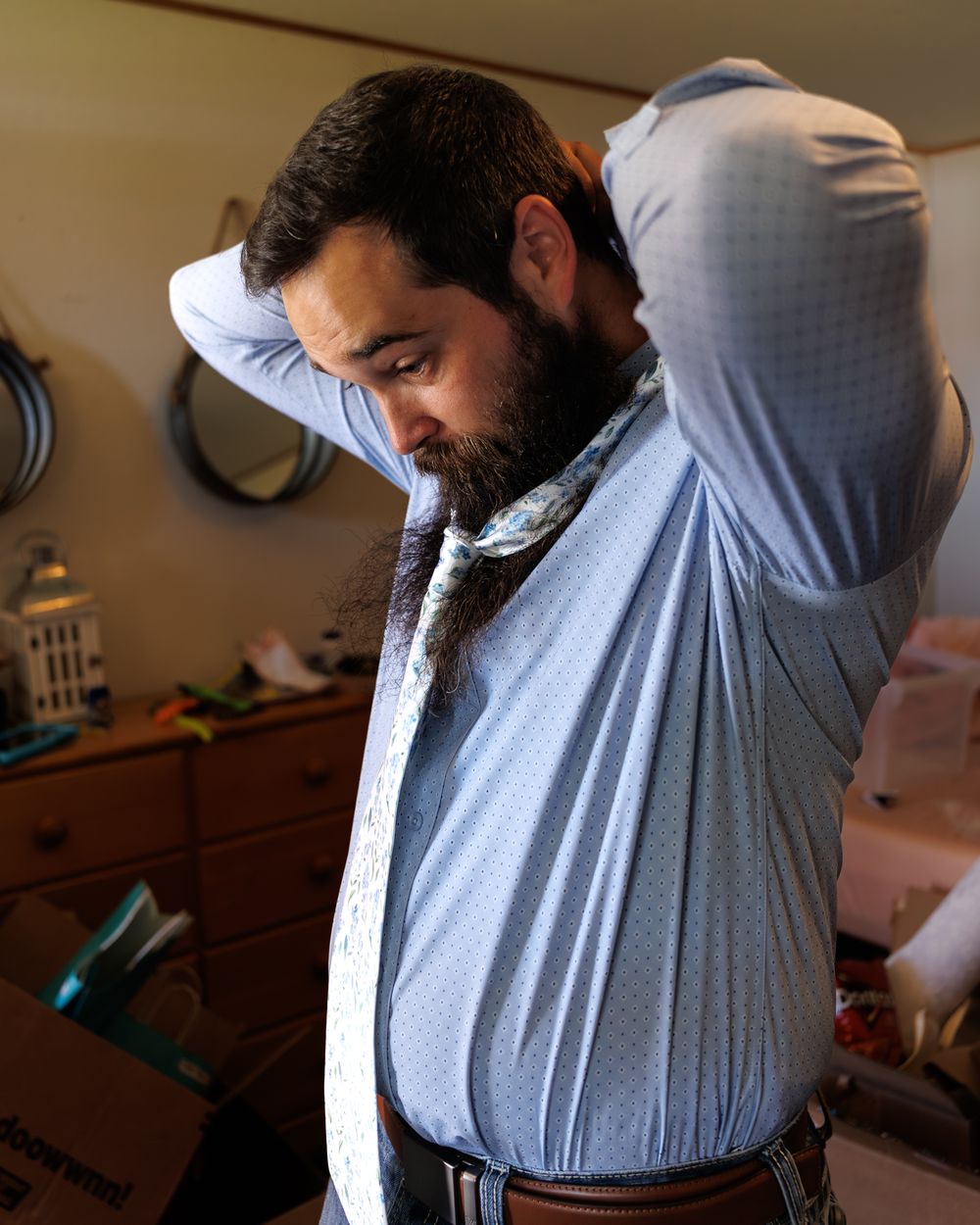Groom getting ready with tie