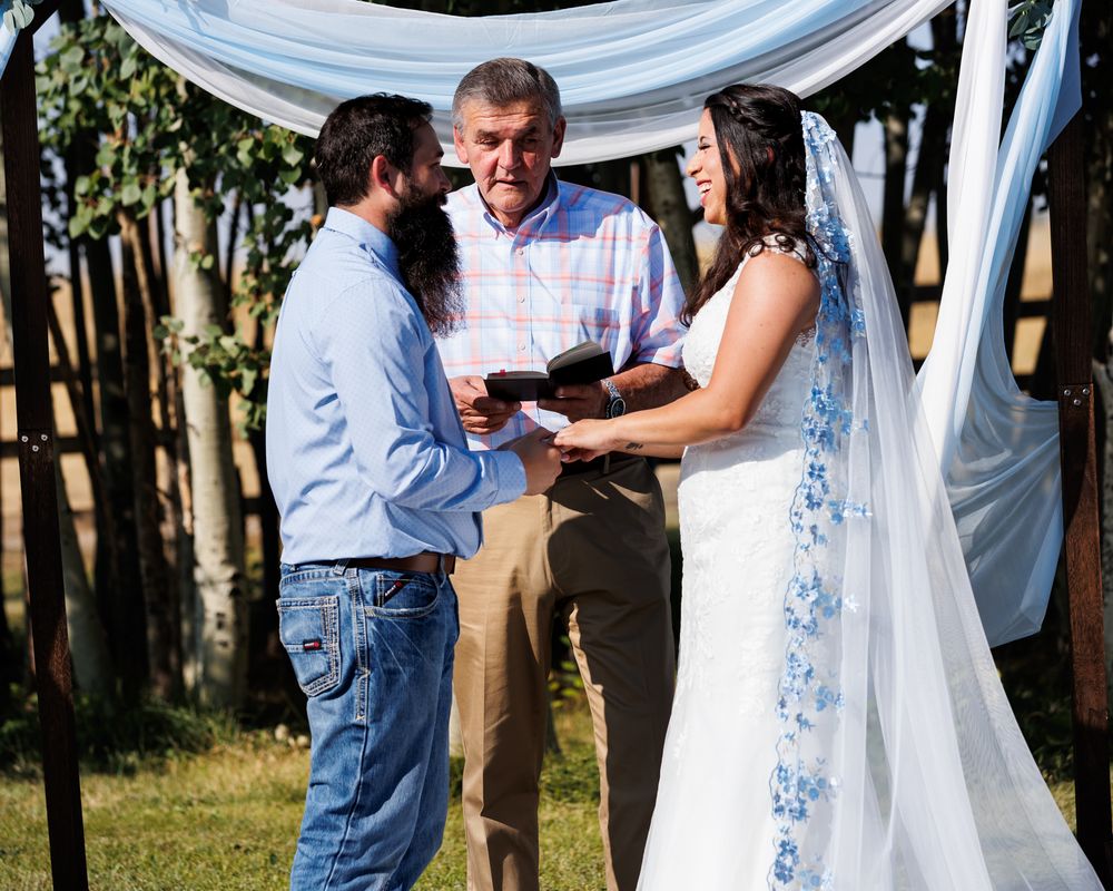 Montana wedding photographer captures bride and groom with officiant at alter