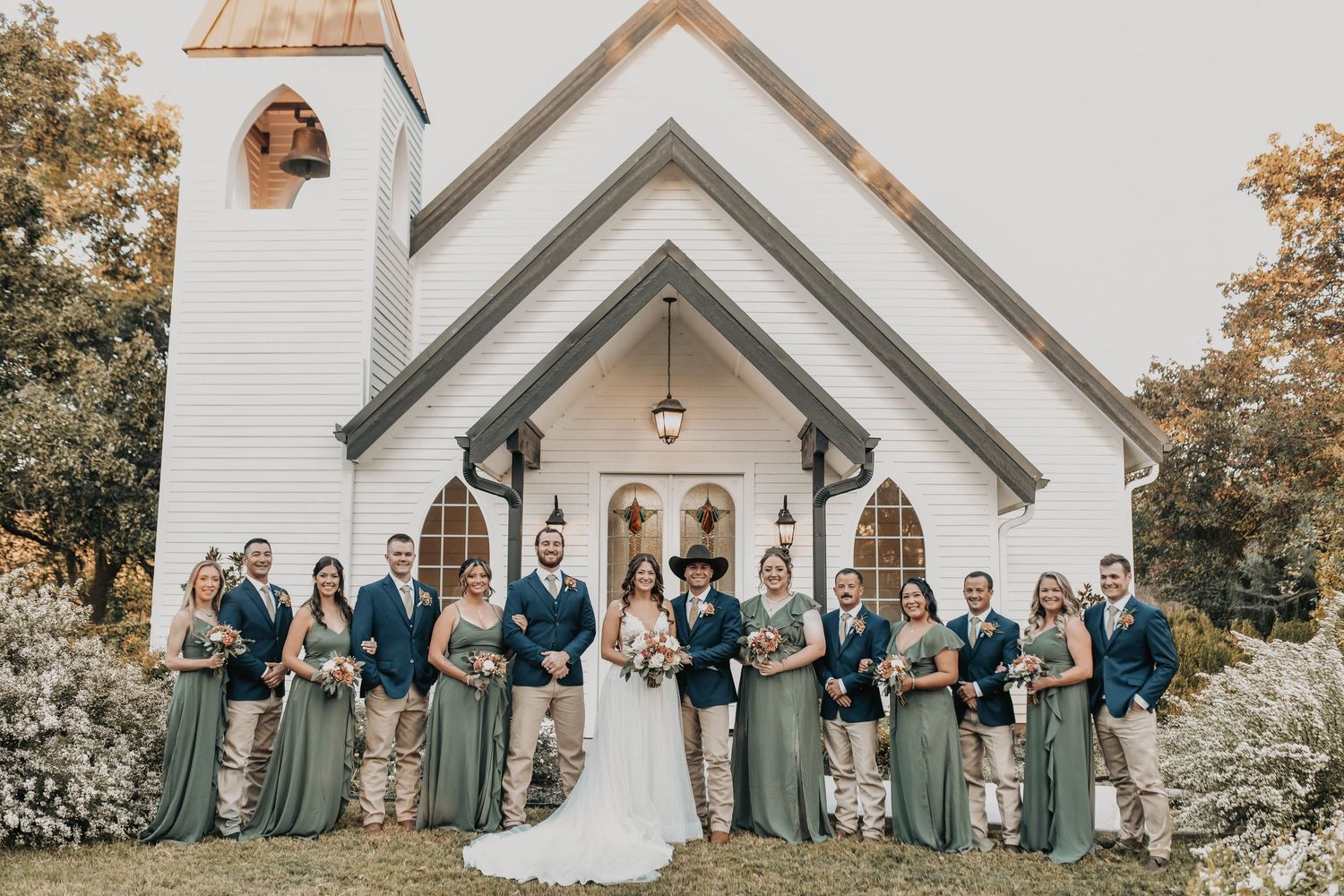Bridesmaids in green dresses at barn wedding venue Texas