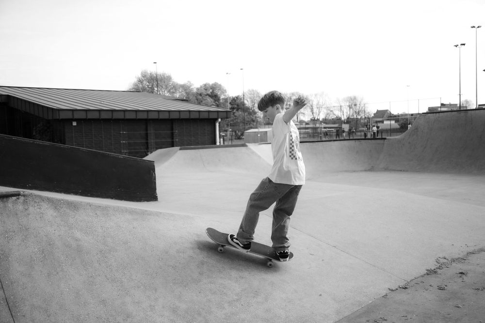 Jongen met skateboard tijdens een persoonlijke communieshoot.