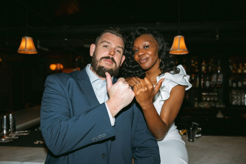A wedding couple shares a romantic dance together at an evening reception venue.