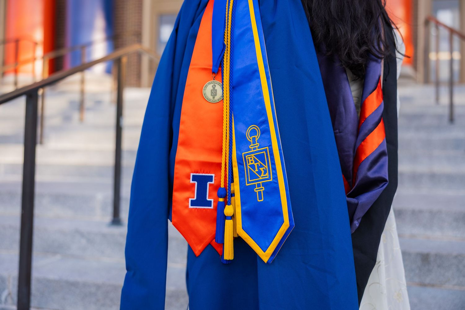 UIUC graduation photo with stole, cords, and hood provided by the university