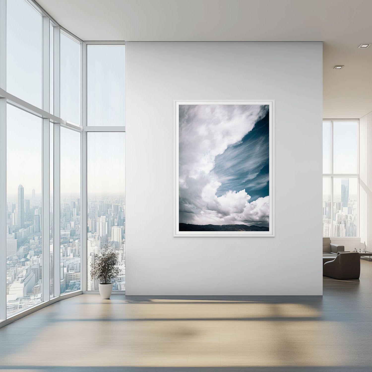 Framed cloud photography art print displayed on white wall in modern high-rise interior with city skyline views.