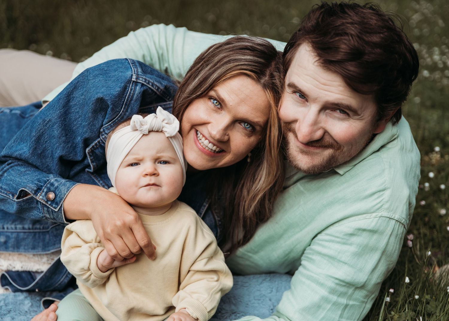 A happy family enjoying a tender outdoor moment together in nature.