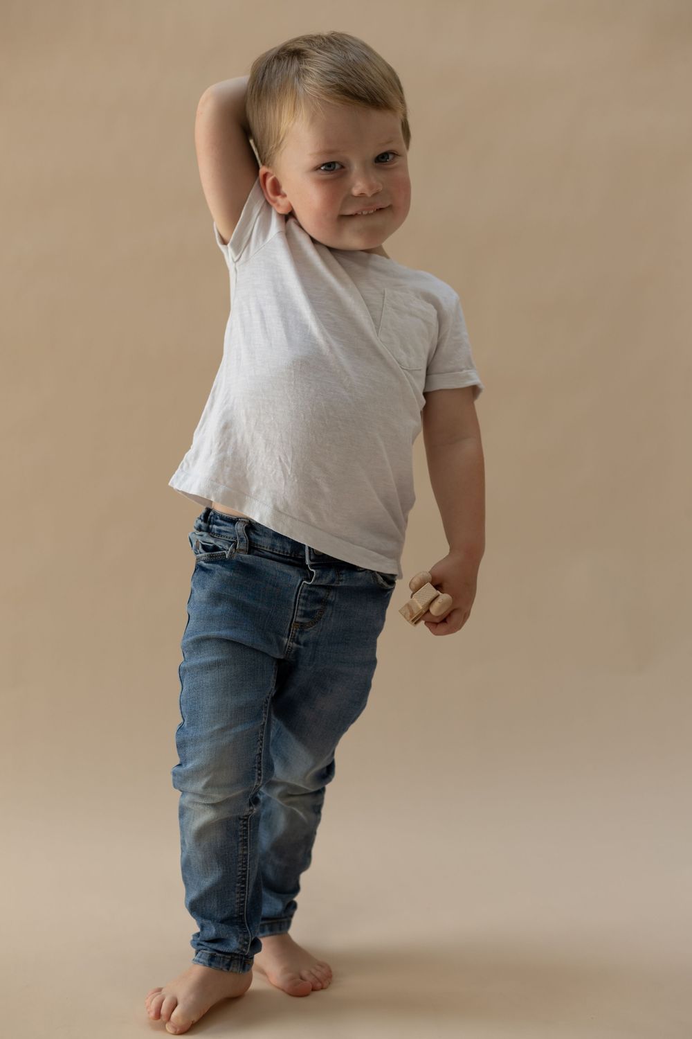 A beautifully lit photograph of a toddler during a relaxed milestone studio photography session in Bedfordshire.