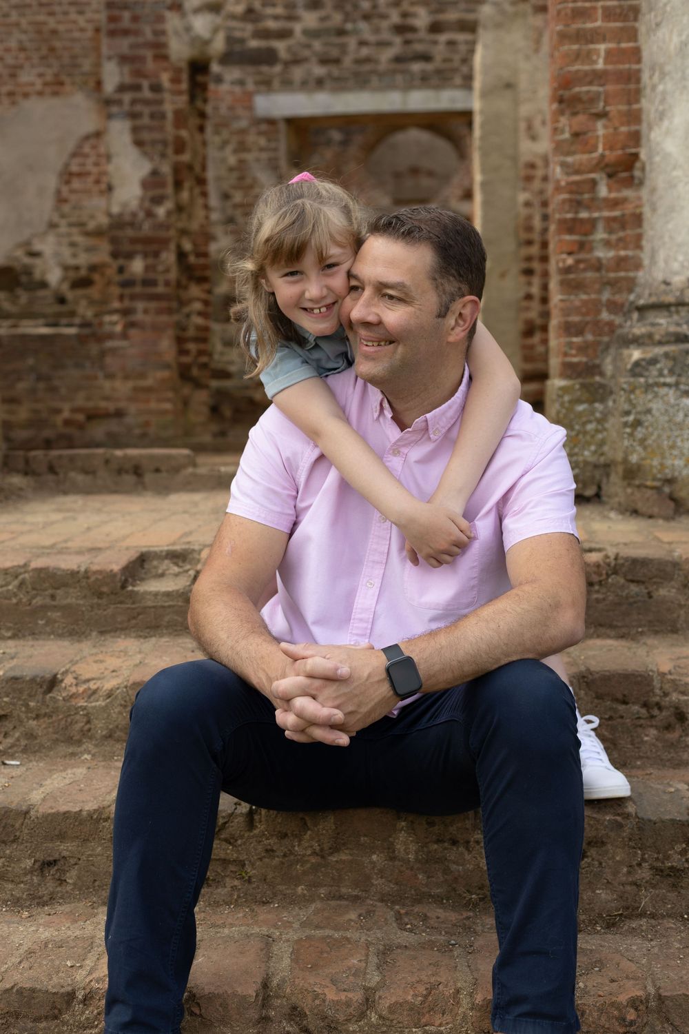 A photograph of a beautiful moment between father and daughter during a relaxed outdoor family photography session in bedfordshire.