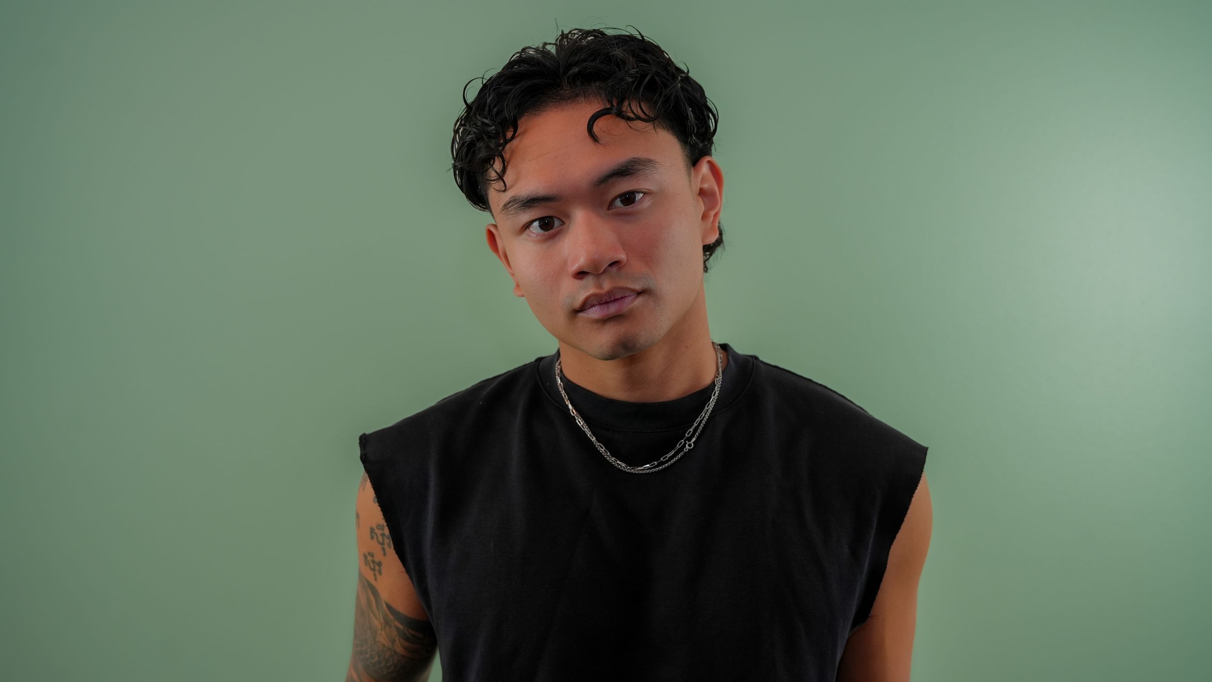 A series of six headshots showing different poses and expressions against a green tinted background.