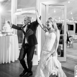 Celebratory dance moment captured in black and white at an elegant wedding reception.