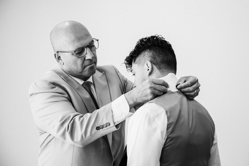 A tender moment captured in black and white during wedding preparations.