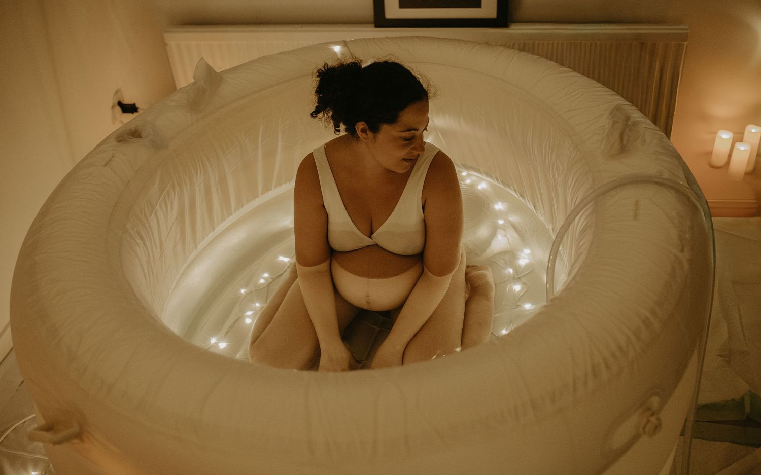 A series of white inflatable pool floats arranged in a row against a neutral background.birth photographer london