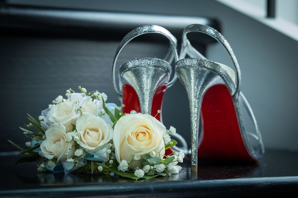 Wedding details with white roses and clear glass accessories arranged artistically.