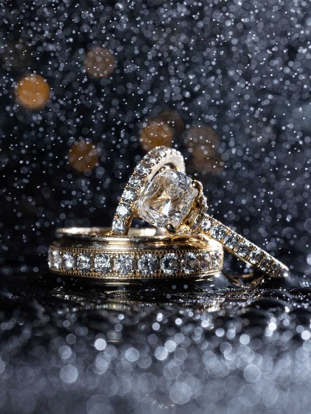 A sequence of sparkling diamond engagement rings on a dark background with glittering bokeh effects.