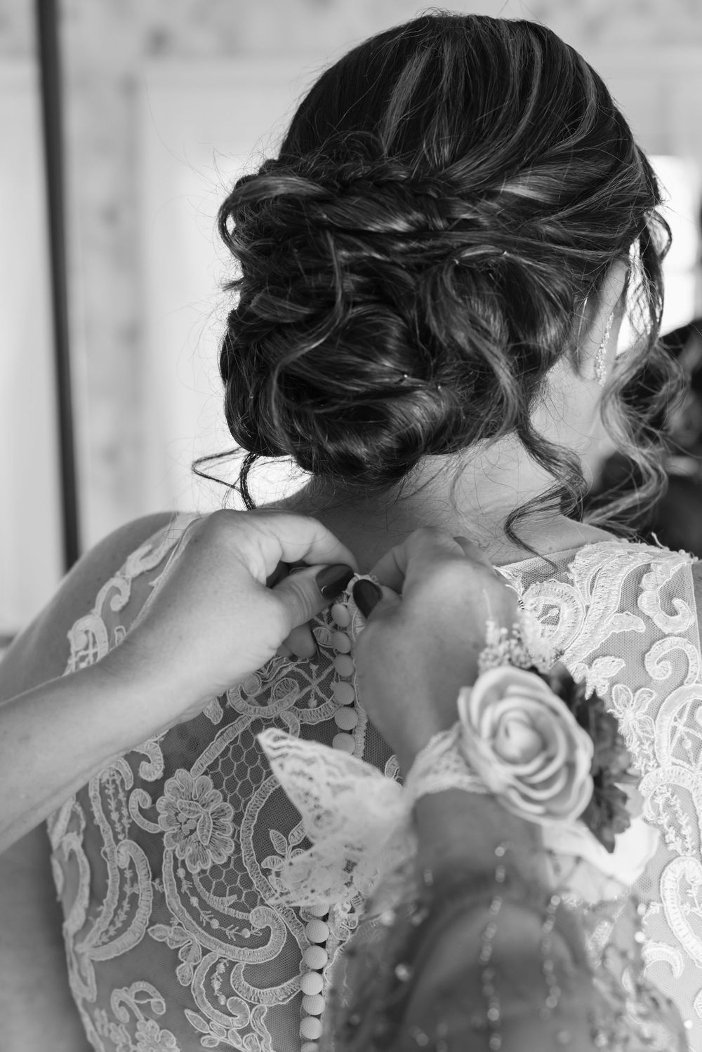 Intricate lace detail on back of white wedding dress with delicate beadwork.