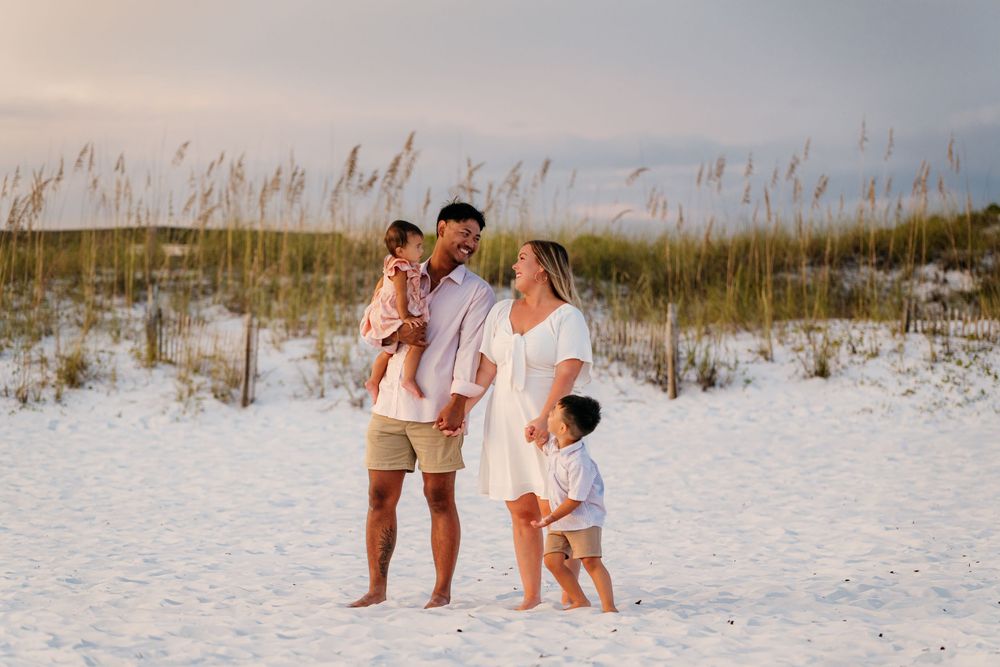 A collection of candid moments captured on a pristine white sandy beach with beach grass and dunes in the background.