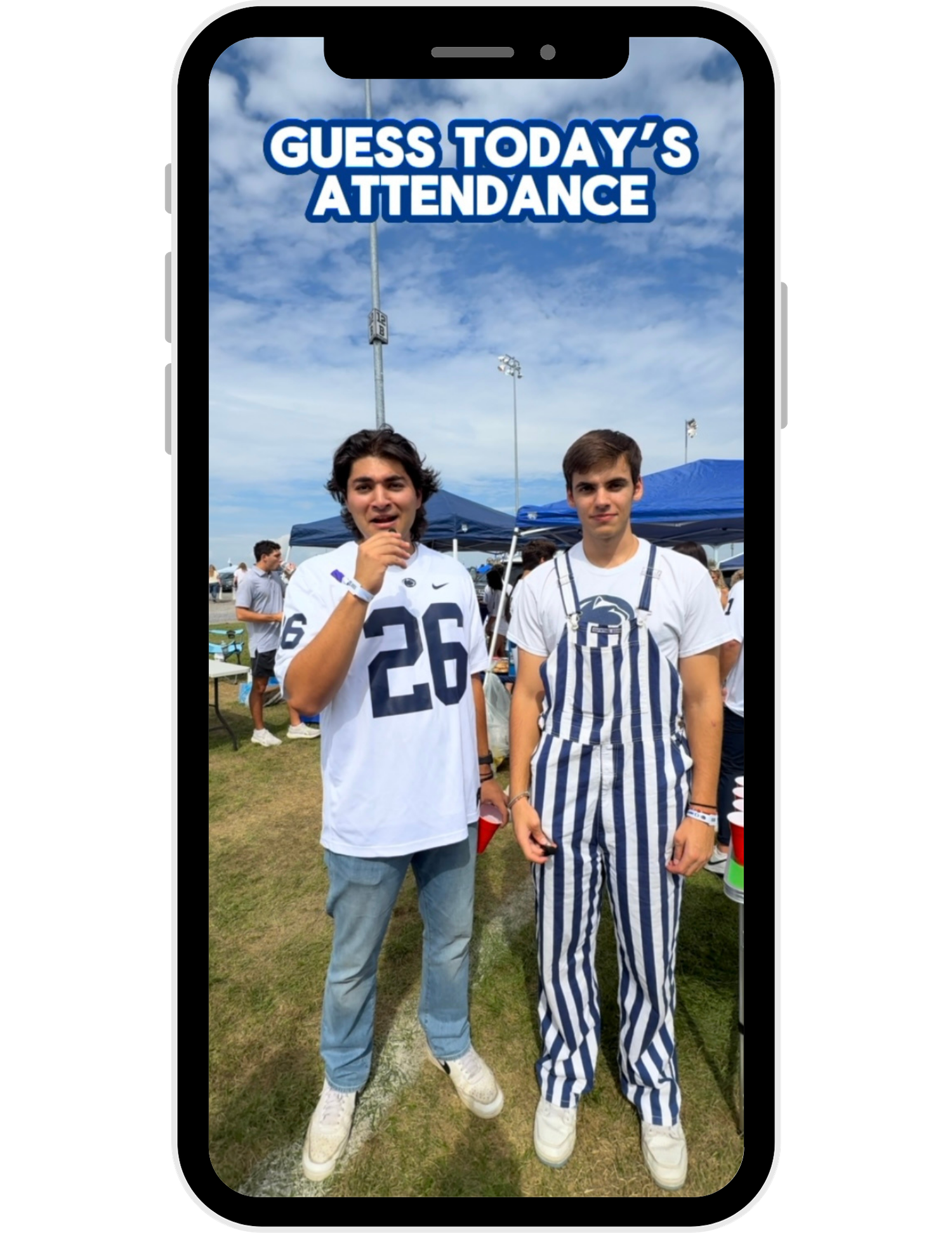 Two people stand together outdoors wearing matching blue and white striped outfits.