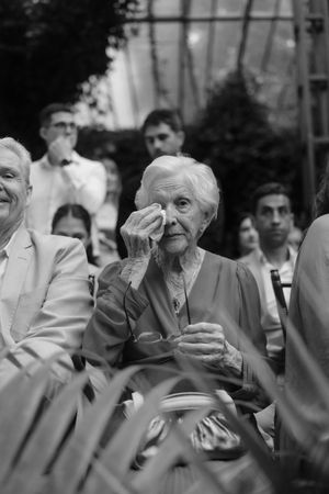 A sequence of black and white photos showing emotional reactions and expressions of people at an event.