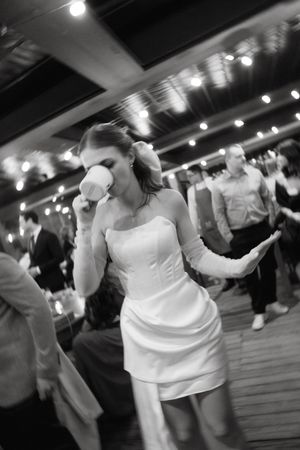 Sequence of dance moves at a wedding reception showing twirling and spinning in white dress under dim lighting.