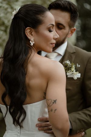 A romantic wedding couple shares intimate moments in a series of close-up shots while dressed in formal attire.