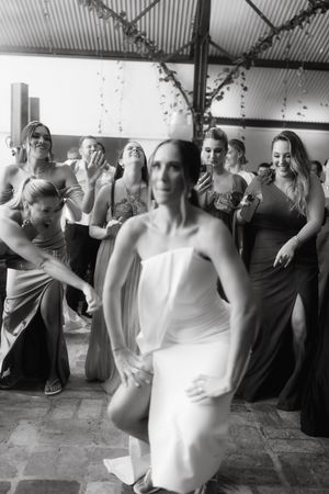 A sequence of black and white photographs showing people dancing and moving energetically at a social gathering.