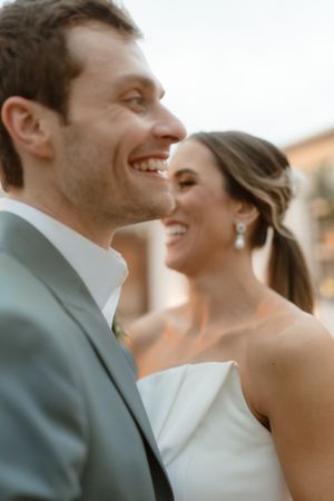 A couple shares joyful moments together in a series of candid wedding photos with soft lighting and blurred backgrounds.