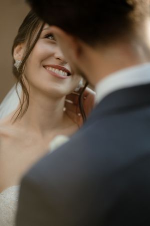 A romantic wedding moment captured in a series of close-up shots showing tender glances between the bride and groom.