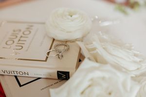Elegant Louis Vuitton branding materials and packaging displayed in soft white tones.