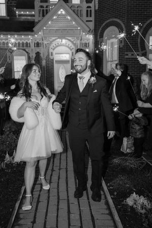 A series of black and white photos showing a couple dancing and celebrating during their wedding festivities.