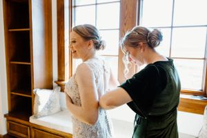 Wedding dress being adjusted in preparation for the ceremony.