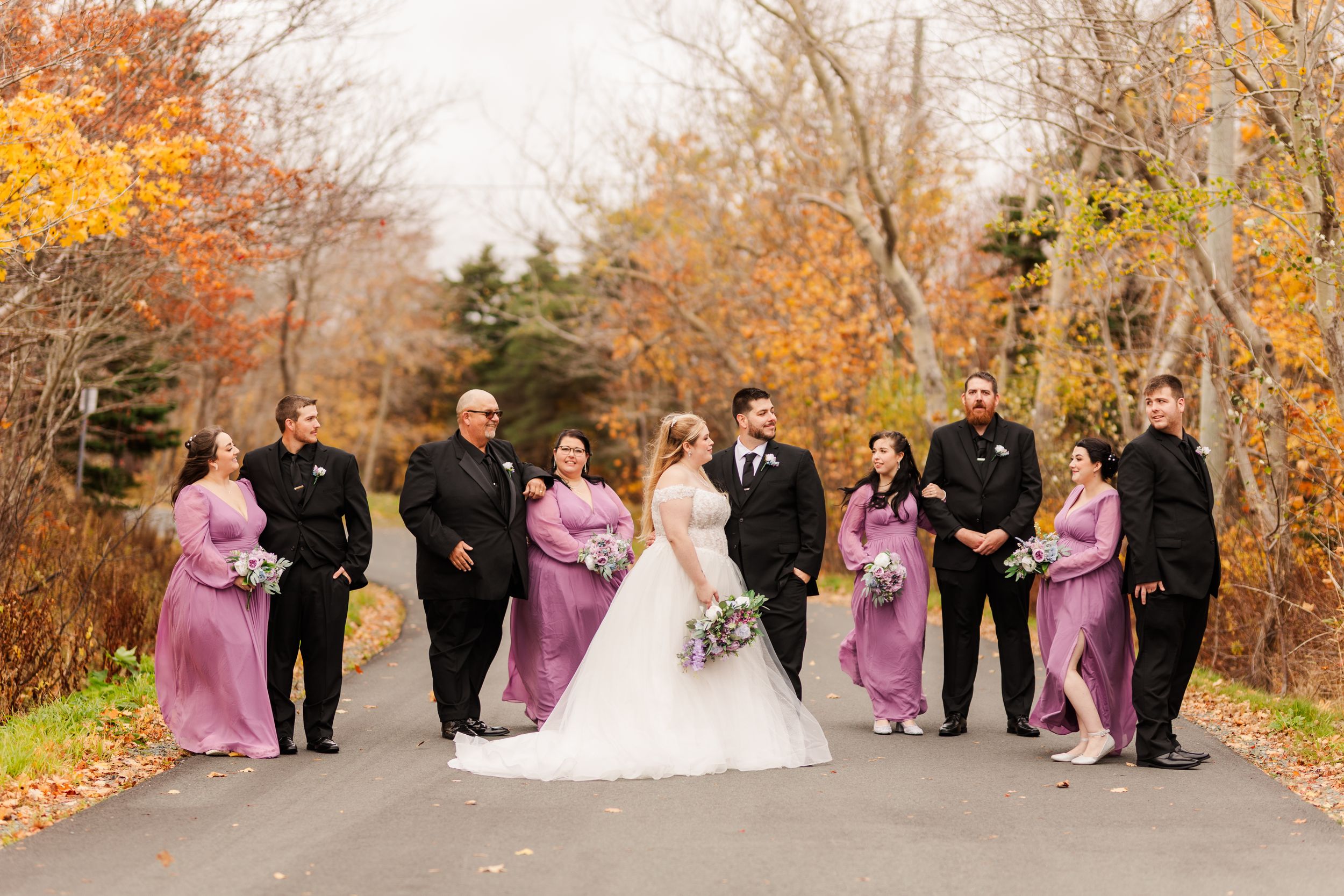 A romantic black and white photo series of a bride and groom sharing intimate moments among fallen autumn leaves.